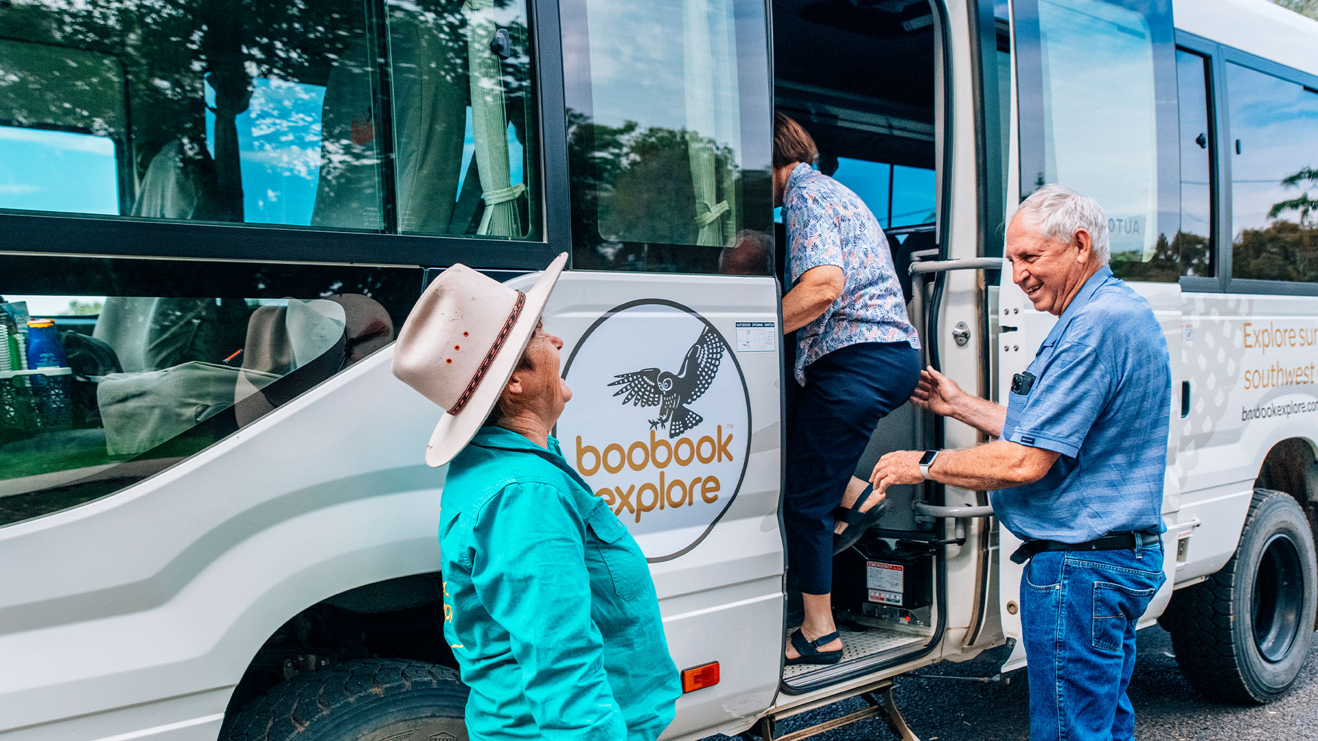 A Boobook Explore host greeting guests as they board a 4WD bus